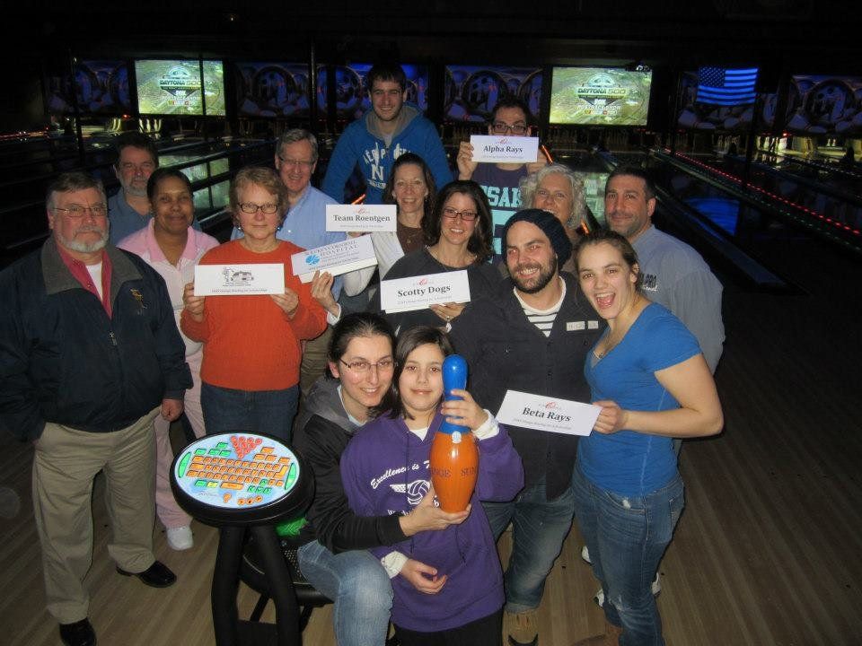 SUNY Orange alumni bowlers holding name signs at the Bowling for Scholarships fundraiser at Quinnz Pinz