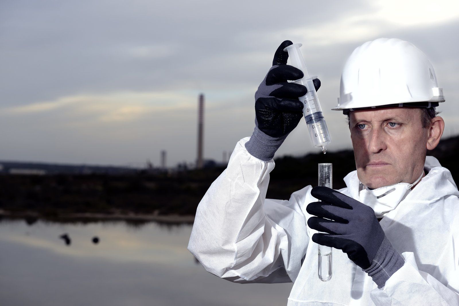 man in white holding a injection