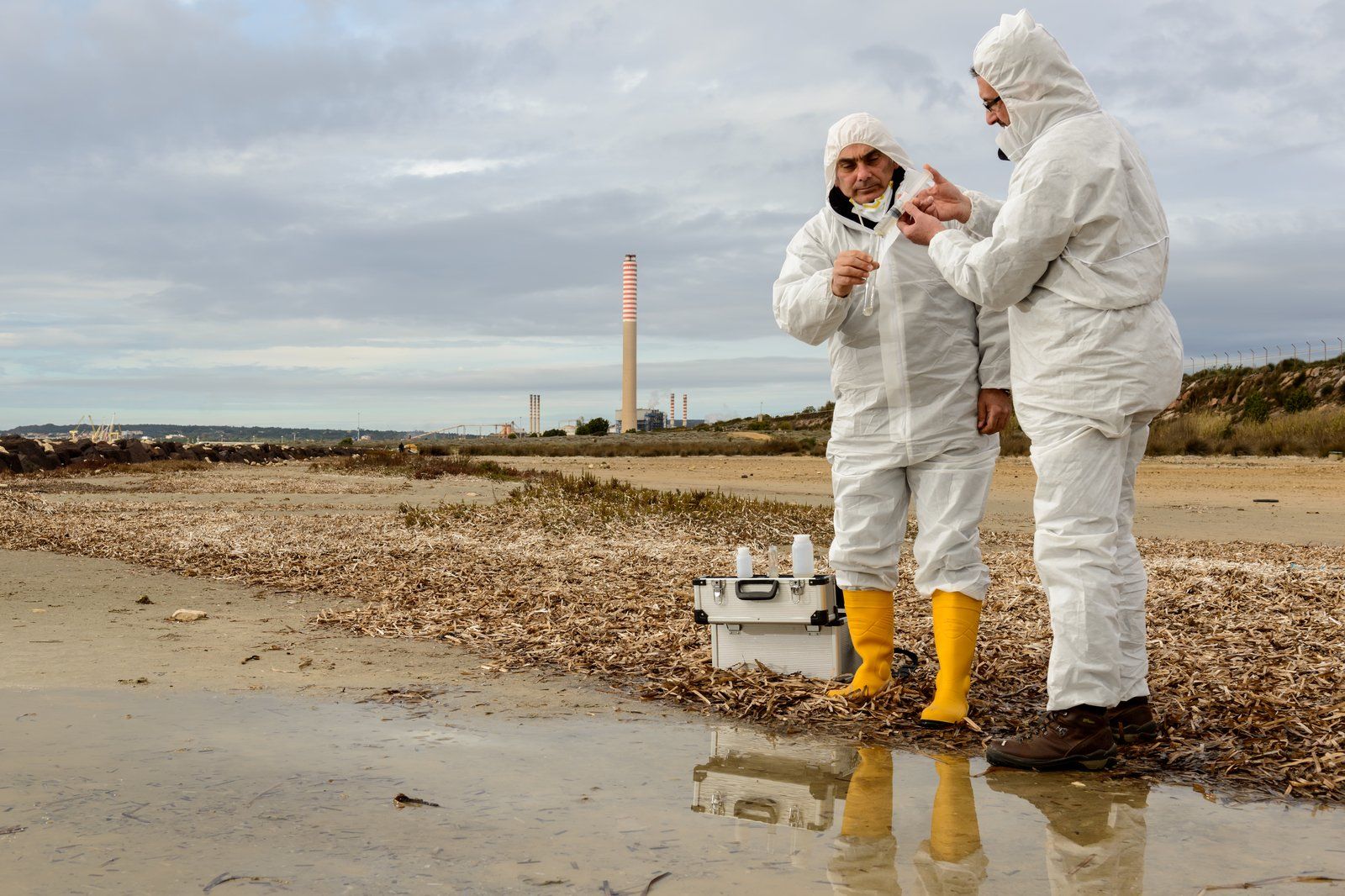 two workers standing in the mud