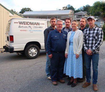 Weidman and Sons employees A group of people standing in front of a wedman van