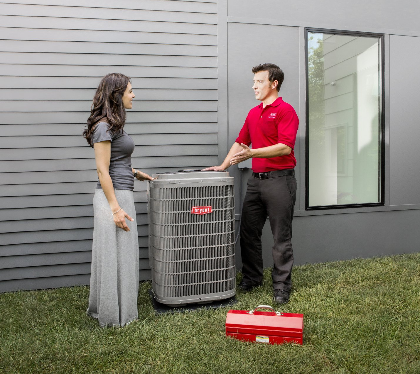 AC Ephrata, PA A man in a red shirt is talking to a woman in front of an air conditioner.