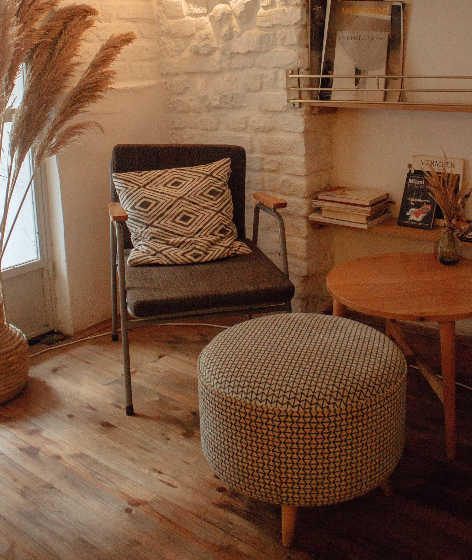 corner chair and table A living room with a chair , ottoman and table