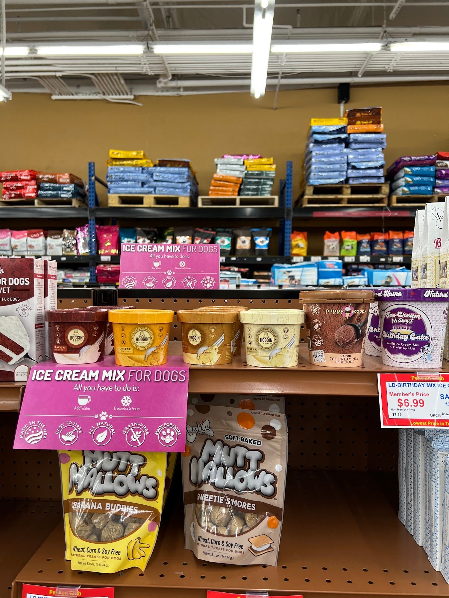 Pet food and treats display in a store. Ice cream mixes and Mutt Mallows dog treats are on the shelf.