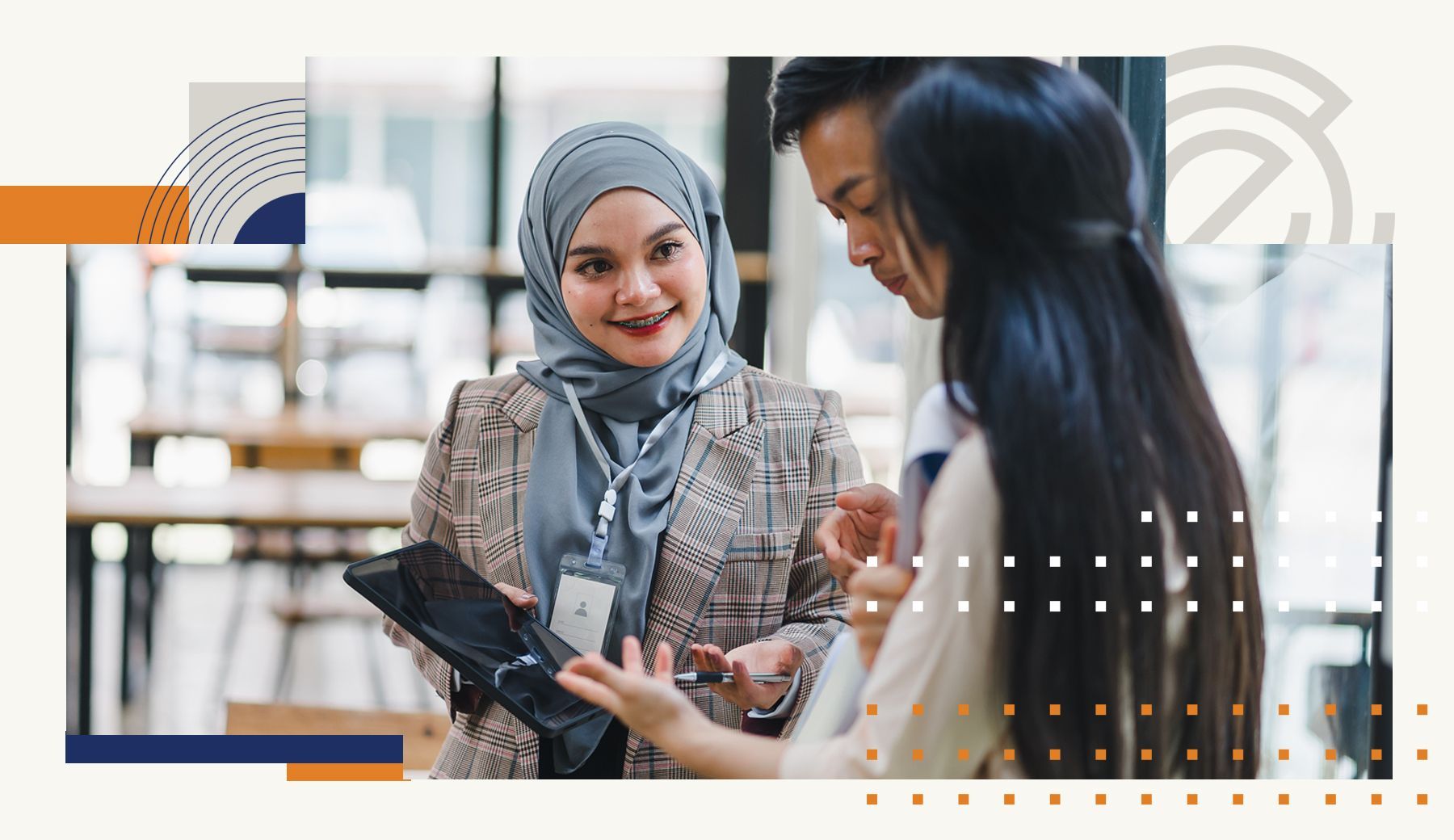 A woman in a hijab is talking to a man and a woman while holding a tablet.