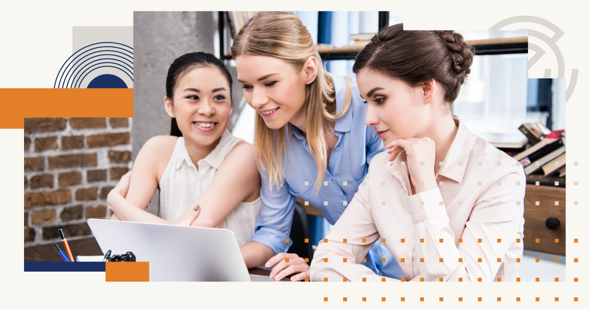 Three women are looking at a laptop computer together.