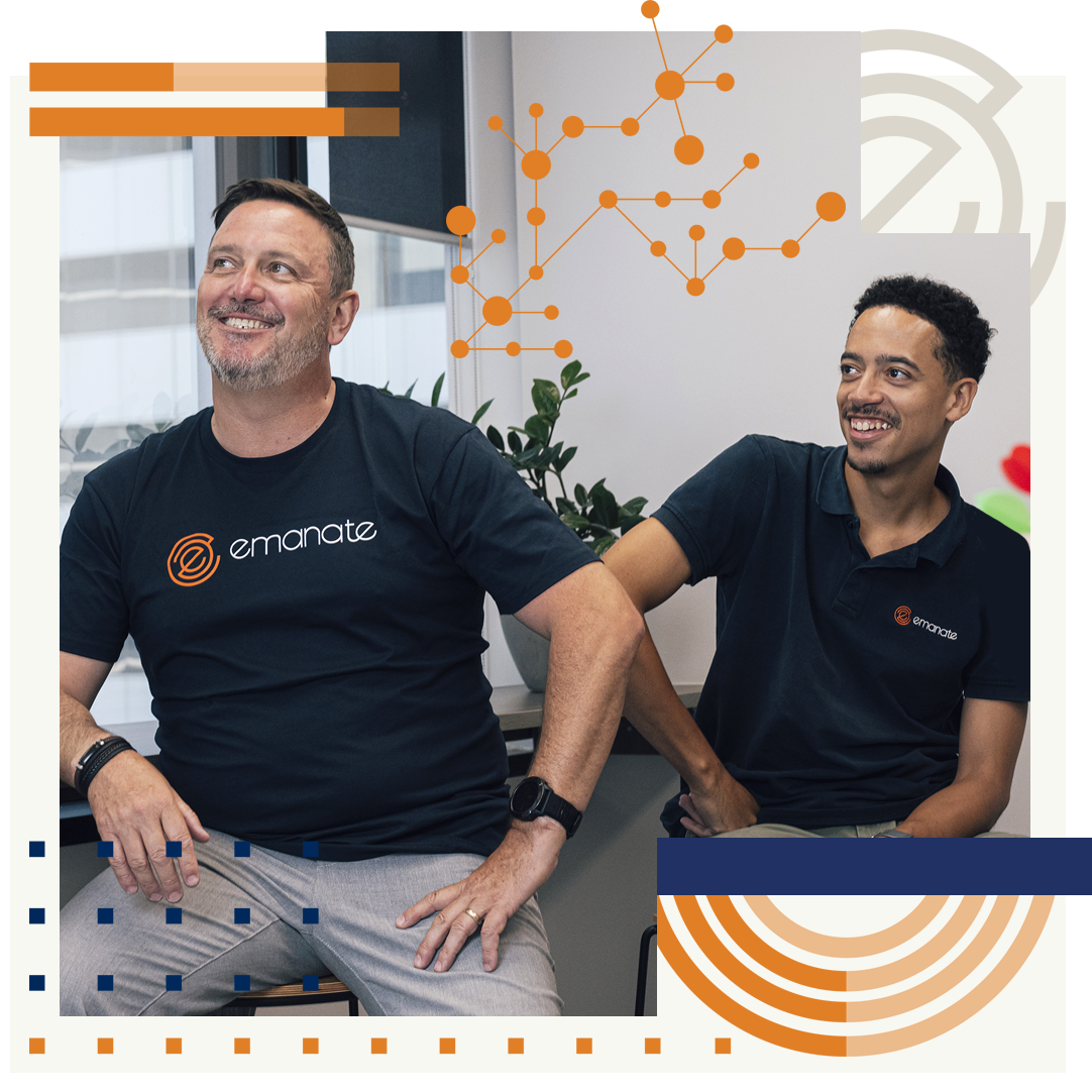 Two men are sitting next to each other and smiling.