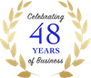 Logo celebrating 47 years of business; blue