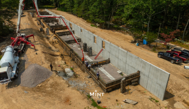 An aerial view of a large concrete wall being built.