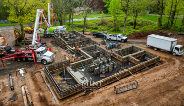 An aerial view of a construction site with trucks and a crane.