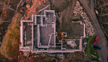 An aerial view of a house being built on a hill.