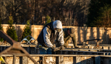 A couple of men are working on a construction site.