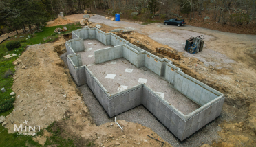 An aerial view of a large concrete basement under construction.