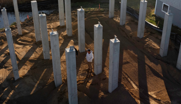 An aerial view of a construction site with a lot of concrete pillars.