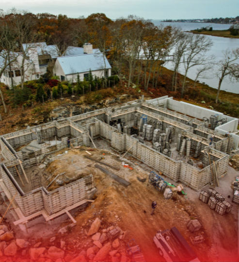 An aerial view of a construction site with a river in the background