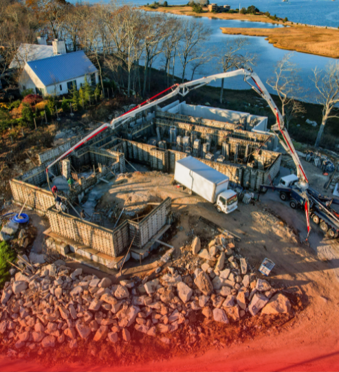 An aerial view of a construction site next to a body of water.