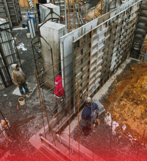 A group of construction workers are working on a wall