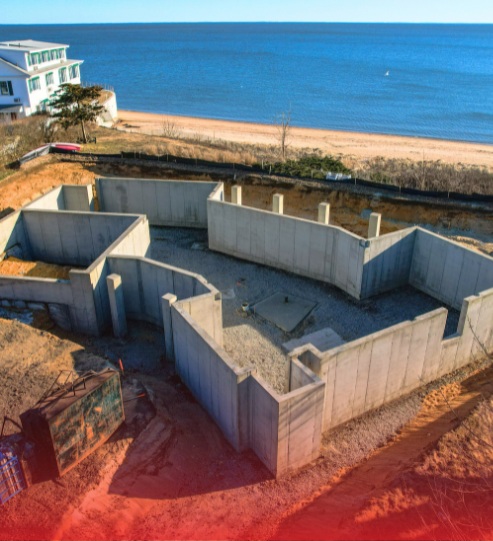 An aerial view of a house under construction near the ocean