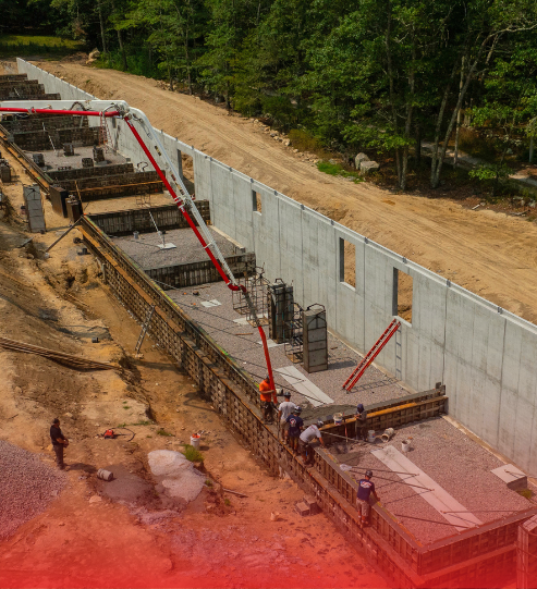 An aerial view of a construction site with a red background.