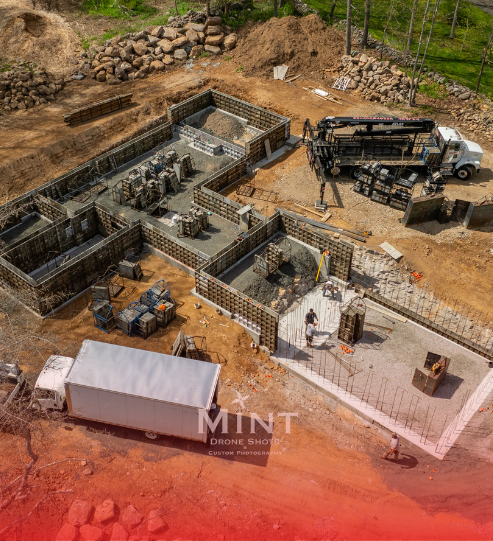 An aerial view of a construction site with trucks and workers.