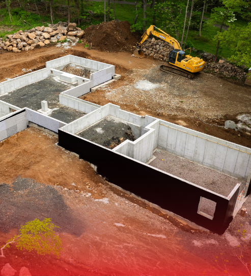 An aerial view of a construction site with a yellow excavator.