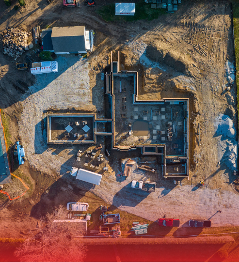 An aerial view of a construction site with a house under construction.