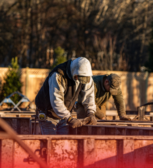 A couple of men are working on a construction site.