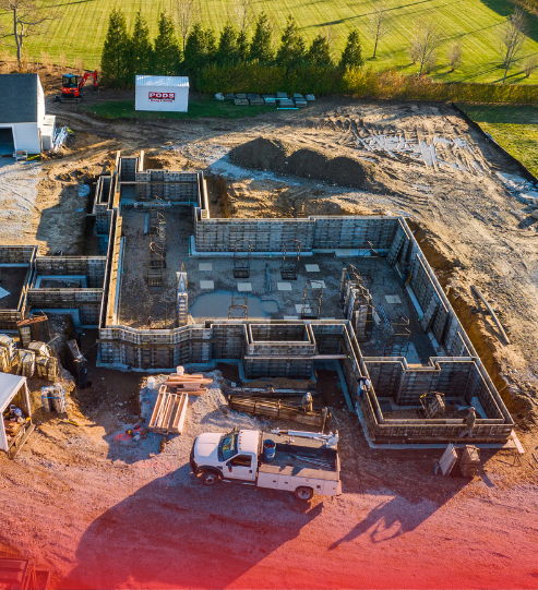 An aerial view of a construction site with a truck in the foreground