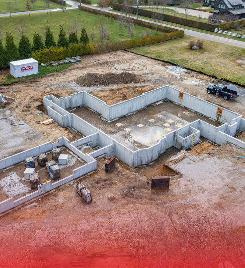 An aerial view of a house under construction in a residential area.