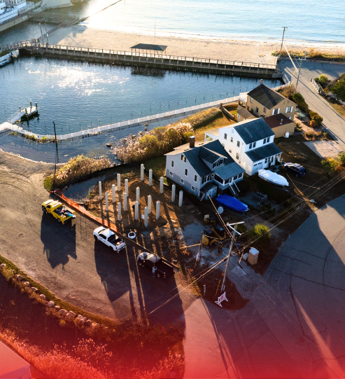 An aerial view of a residential area next to a body of water