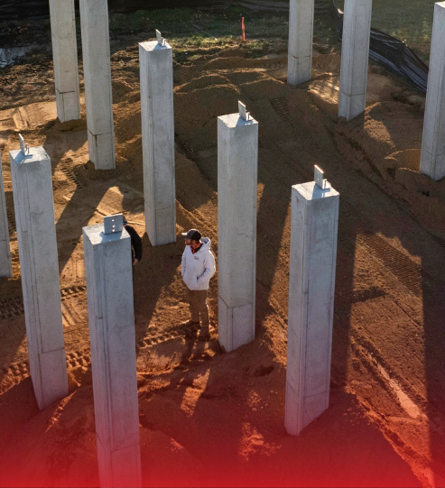 A man standing in a circle of concrete pillars
