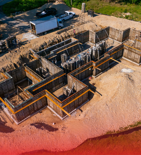 An aerial view of a construction site with a truck parked in the background.
