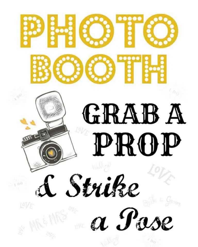 Photo booth sign with gold lettering and camera illustration; text reads 