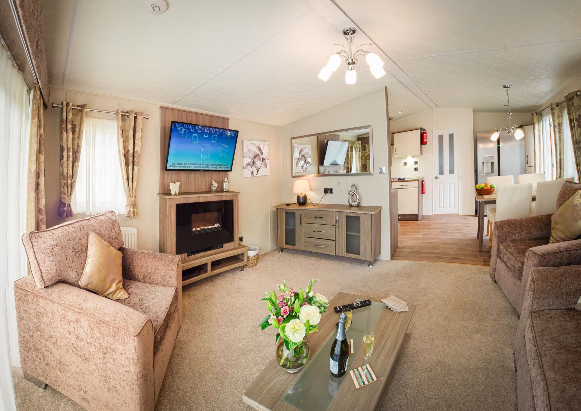 Open plan living area with TV on wall