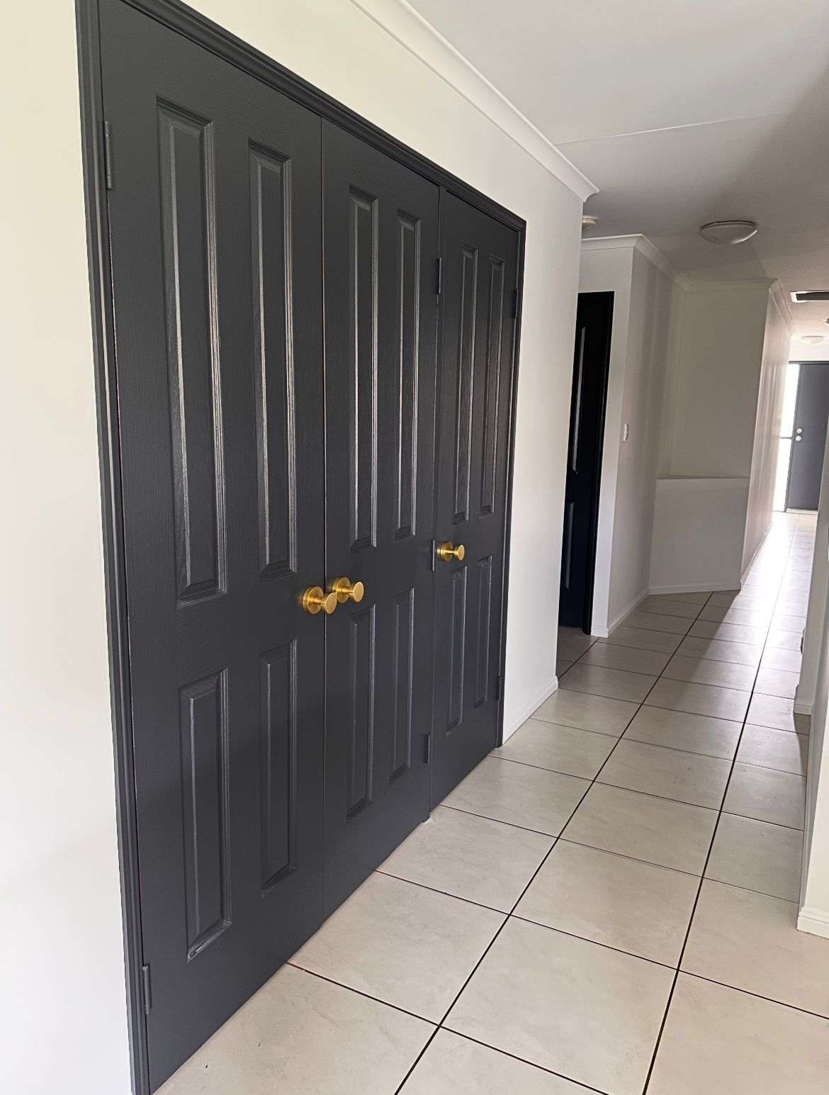 Narrow Hallway With White Walls, Painted Door and Tiled Floor,— MVP Painting Professionals in Glass House Mountains, QLD