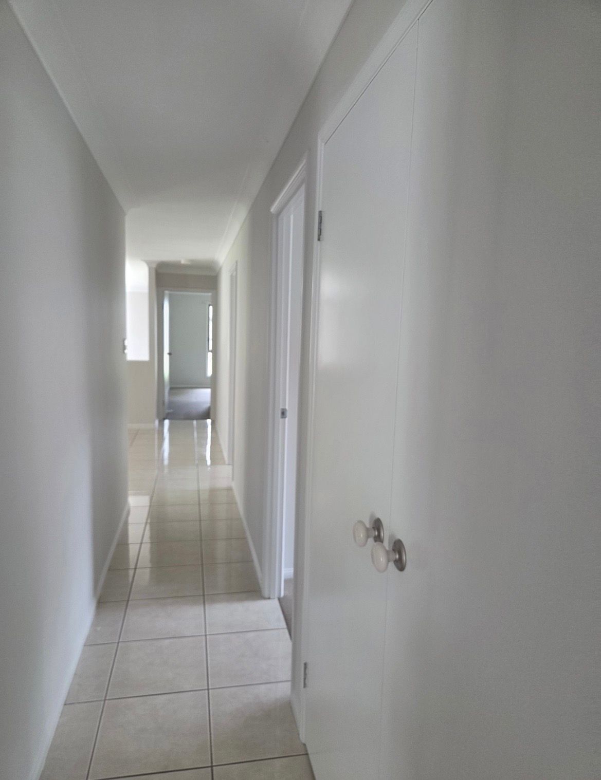 White Narrow Hallway with Tiles and Doors — MVP Painting Professionals in Sippy Downs, QLD