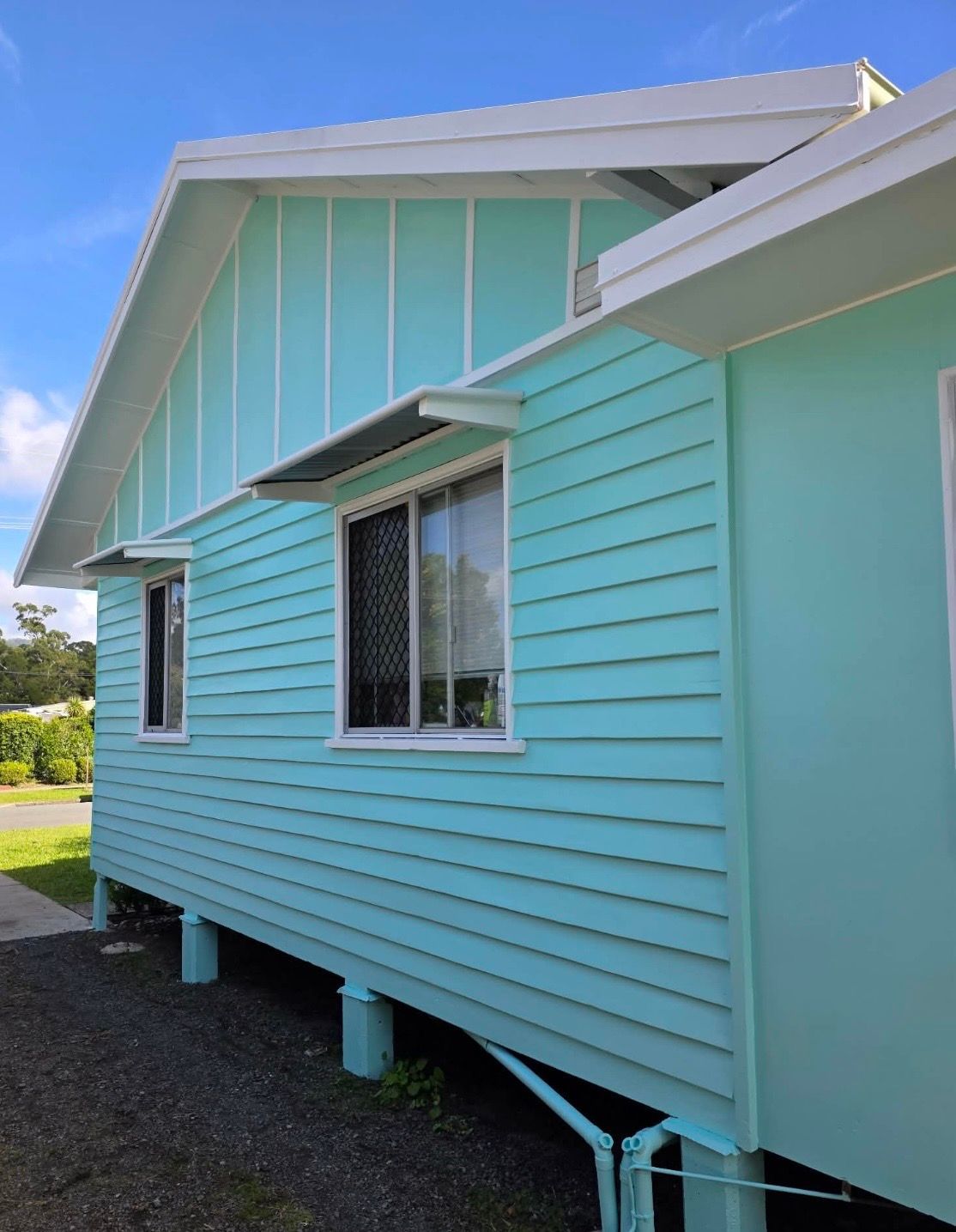 Exterior of Aqua Colour House with Windows — MVP Painting Professionals in Sunshine Coast, QLD