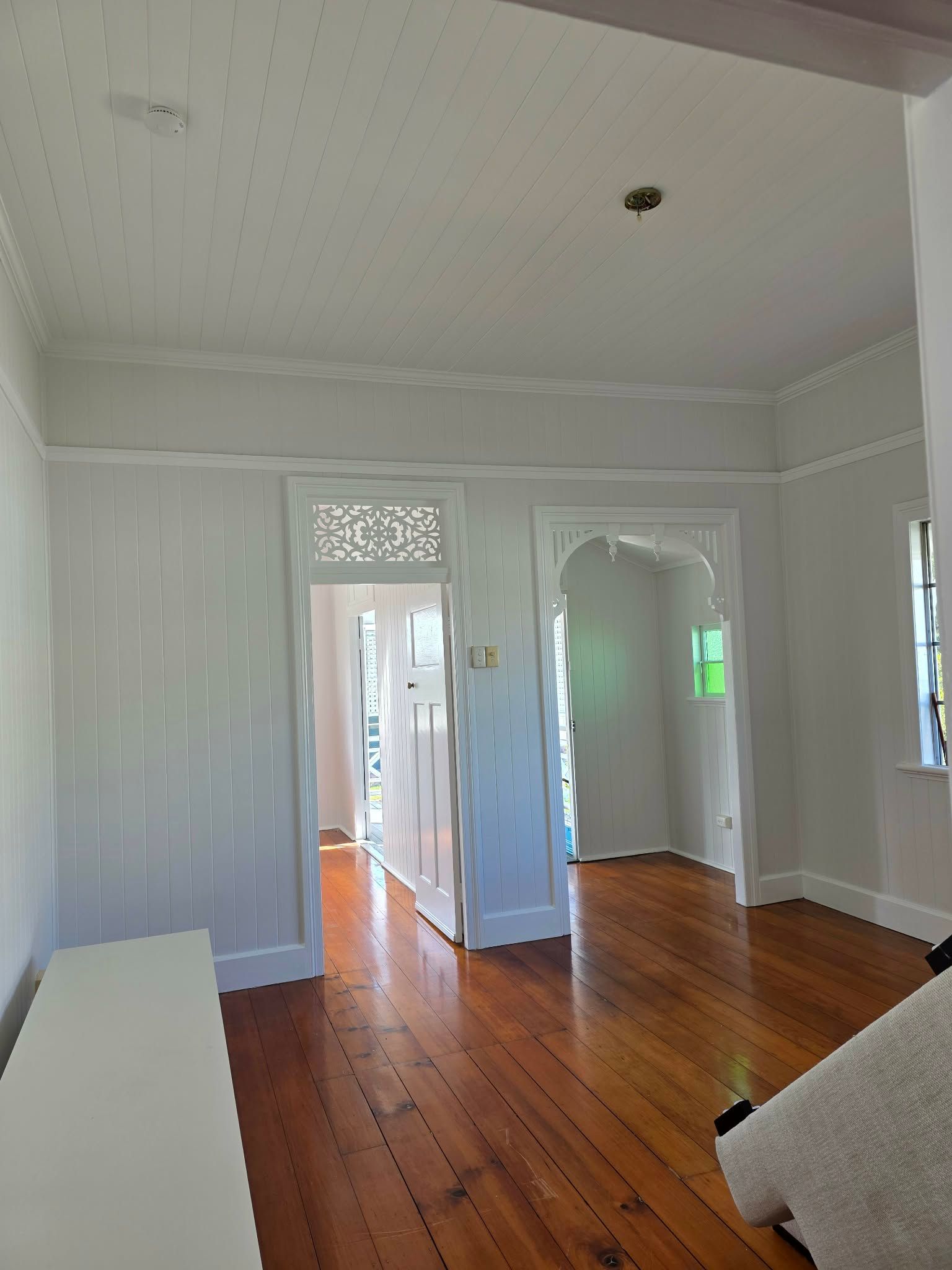 Interior view of a white room with hardwood floors, doorways, and decorative trim — MVP Painting Professionals in Sunshine Coast, QLD