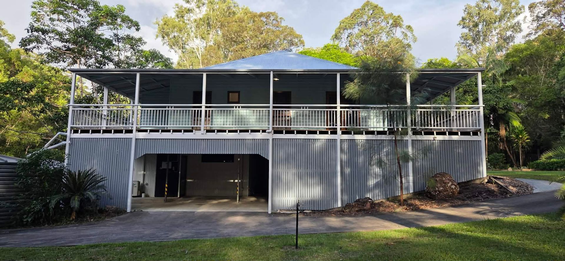 A Light Blue and White House With a Porch, Steps, and a Winding Path — MVP Painting Professionals in Glass House Mountains, QLD