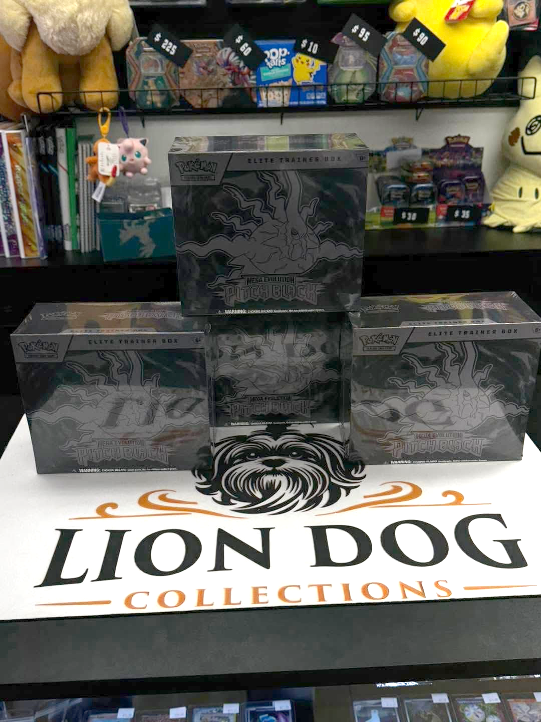 Lion Dog Collections display with three black product boxes on a tabletop in a shop