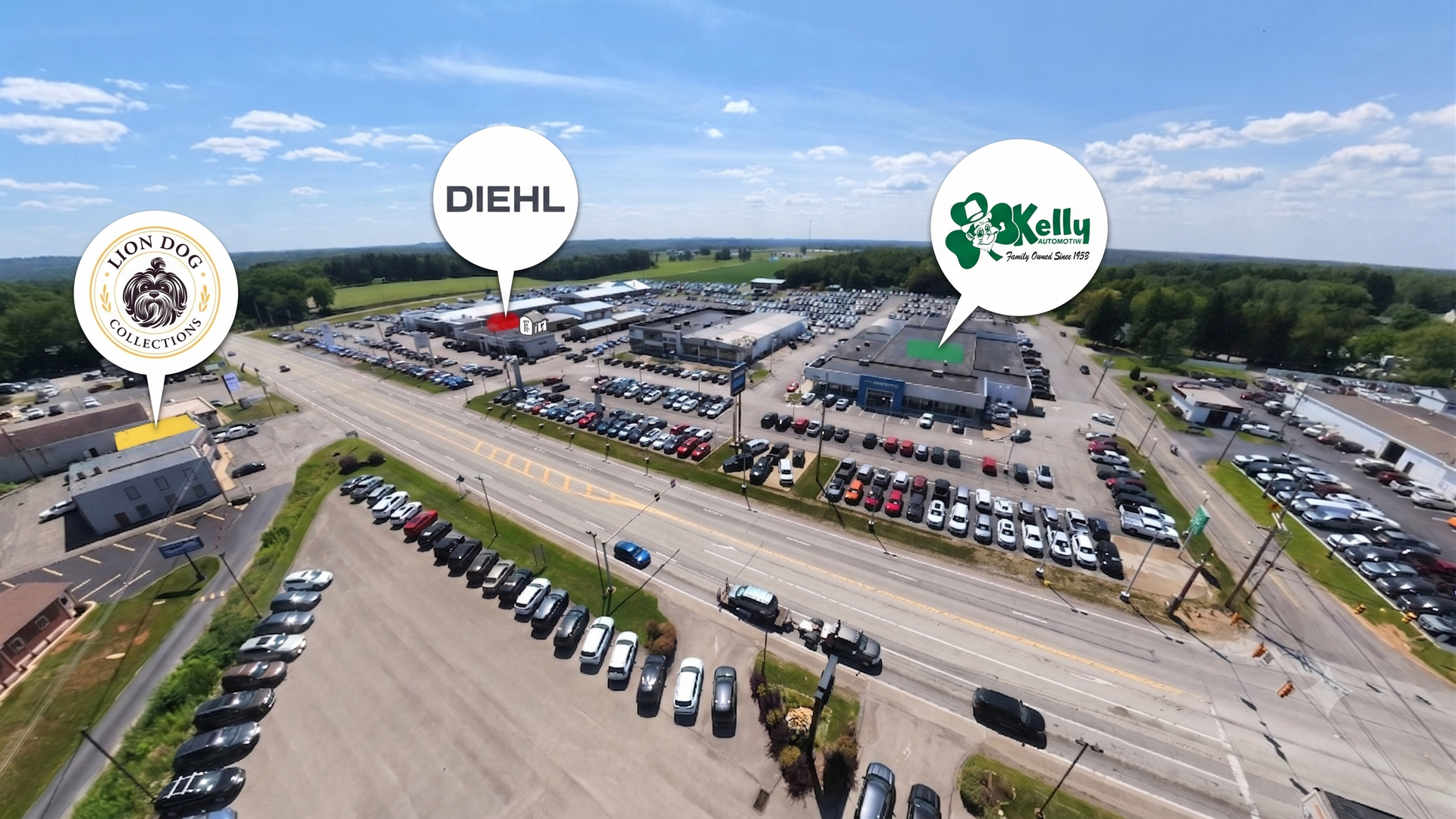 Aerial view of a large parking lot and car dealership with several branded sign markers.