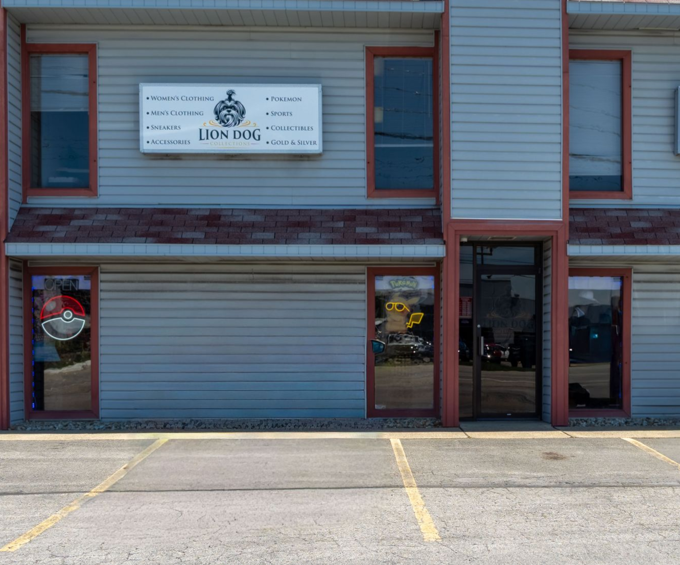 Small storefront with a blue-and-gray facade, windows, and a sign above the entrance.