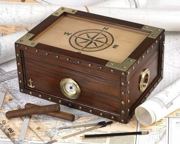 Wooden pirate-style treasure chest with compass rose, brass fittings, map background, and tools around it