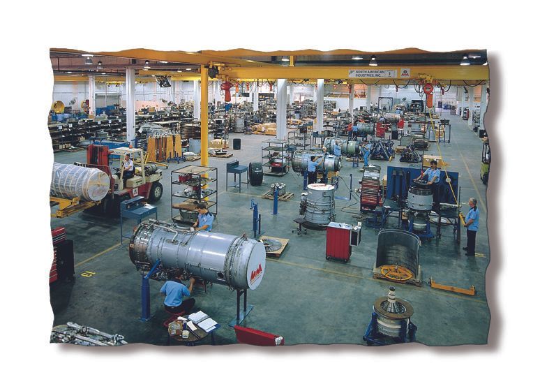 Industrial workshop with machinery and tanks spread across a large factory floor