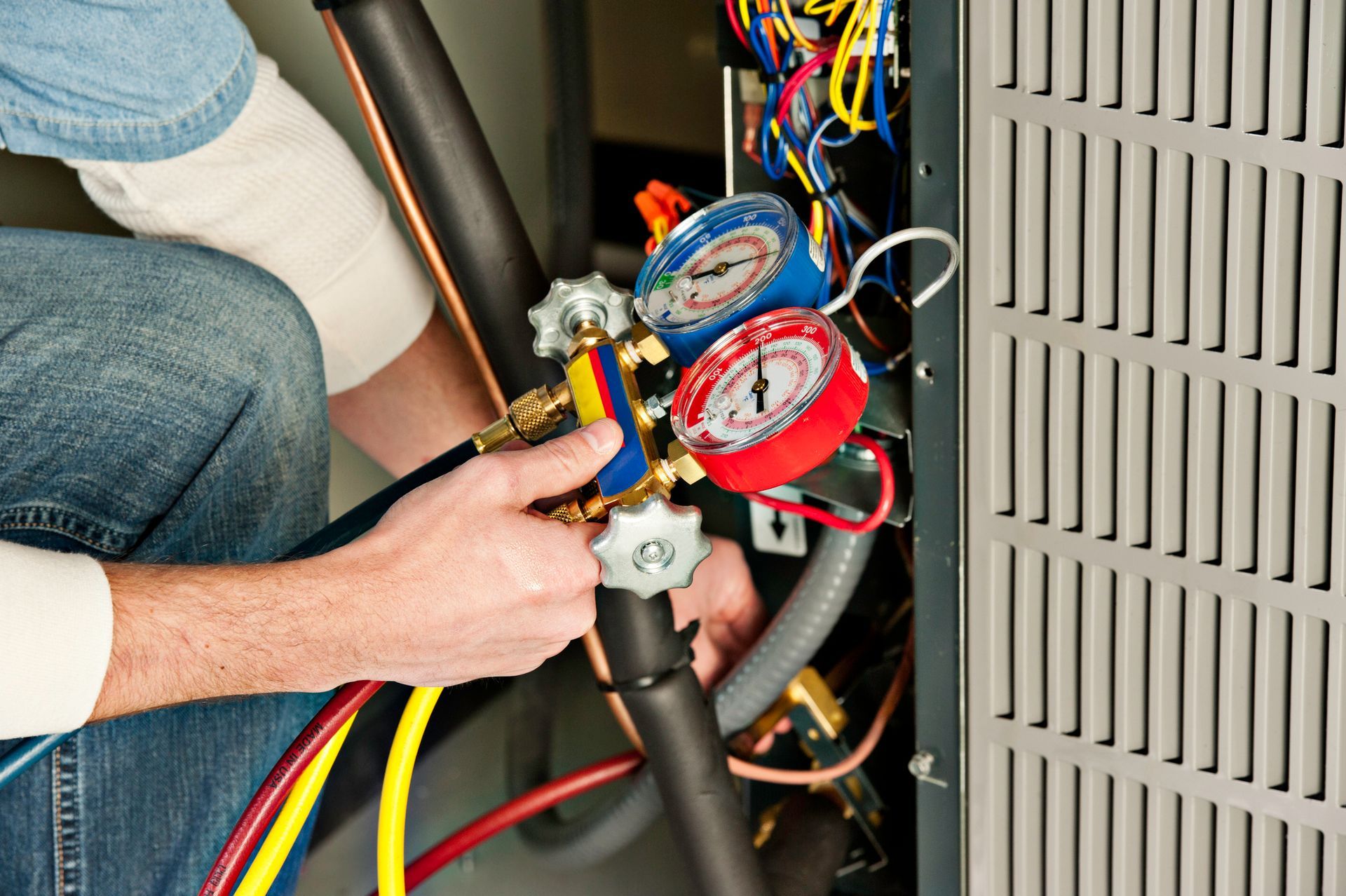 HVAC service technician testing a furnace during fall heating maintenance in Ridgeland, MS.