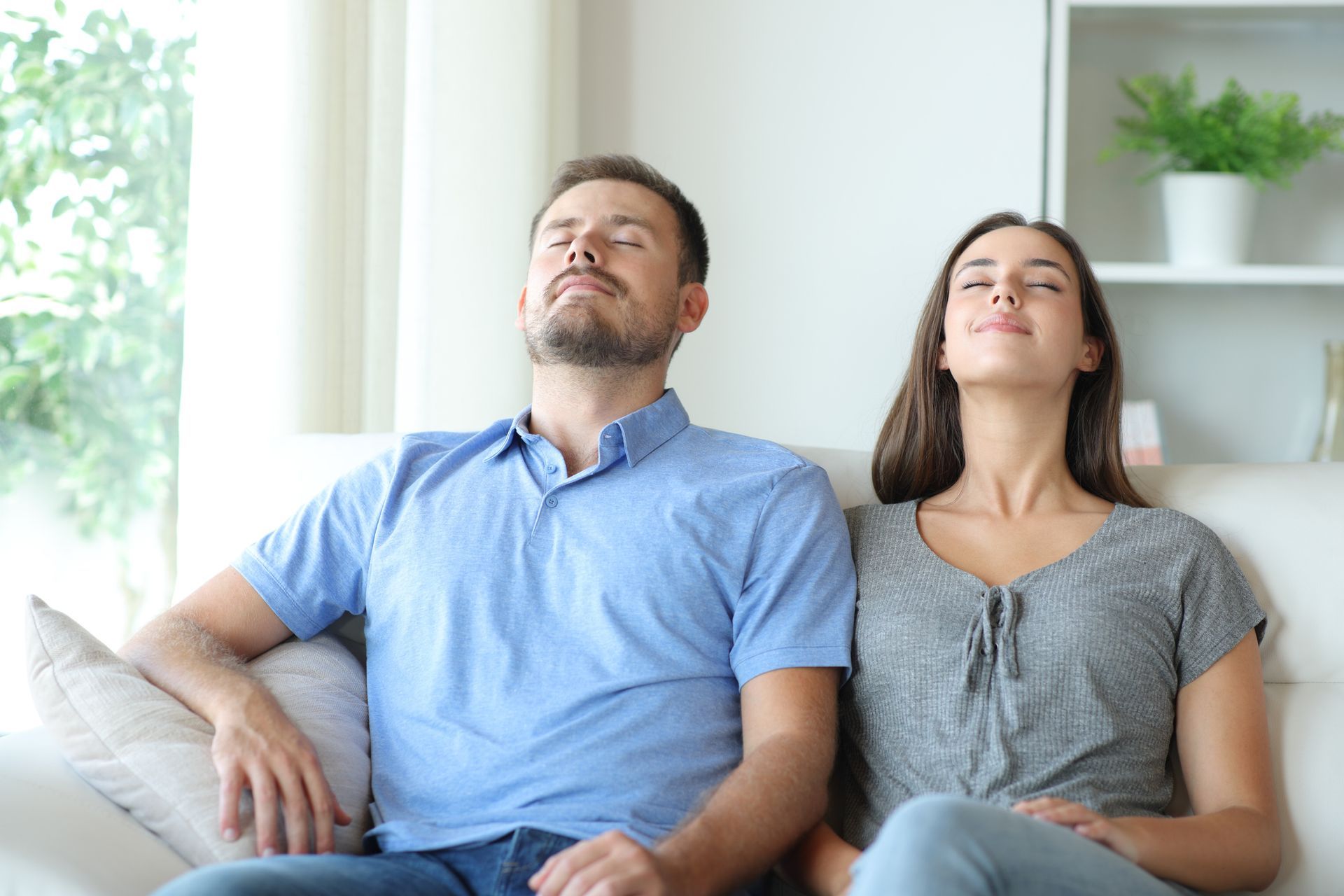 Couple relaxing on a sofa while enjoying clean indoor air in their Ridgeland, Mississippi home.
