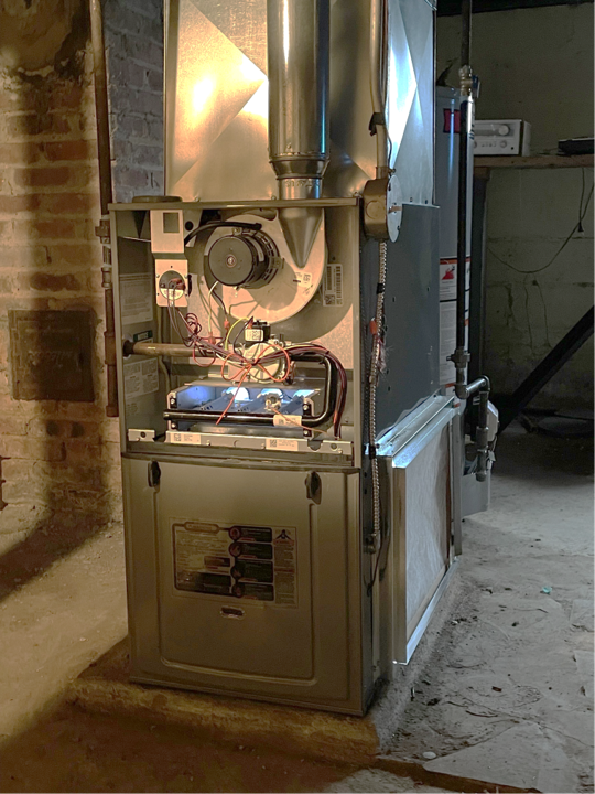 A bathroom with a boiler and a water heater.