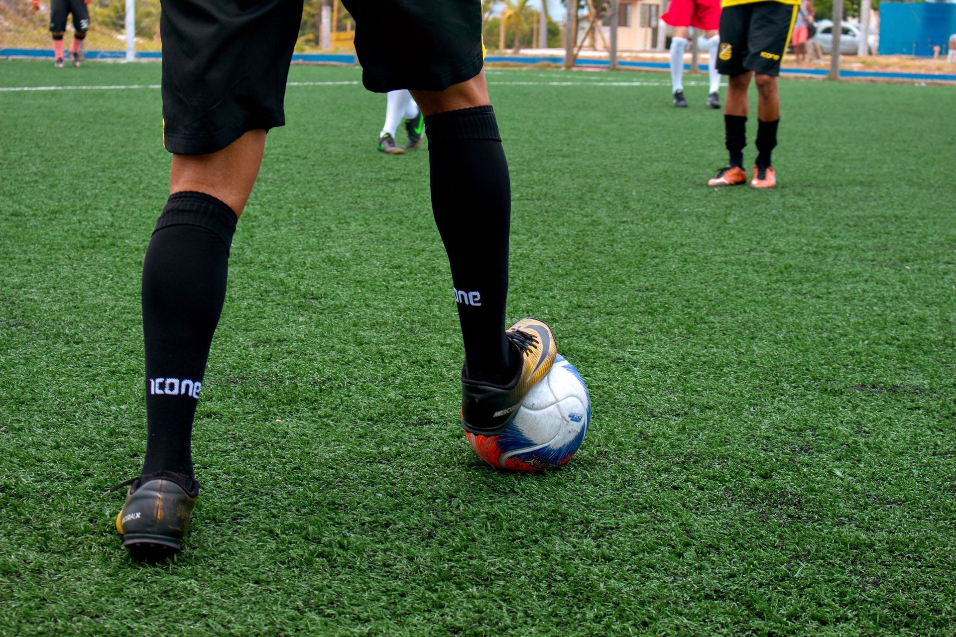indoor soccer field player wih a white soccer ball