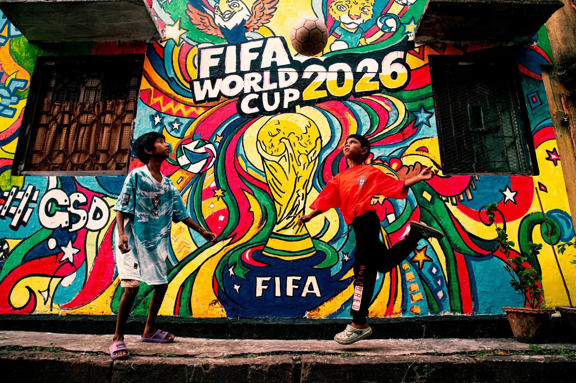 Colorful FIFA World Cup 2026 mural with the trophy and bold street art on a wall