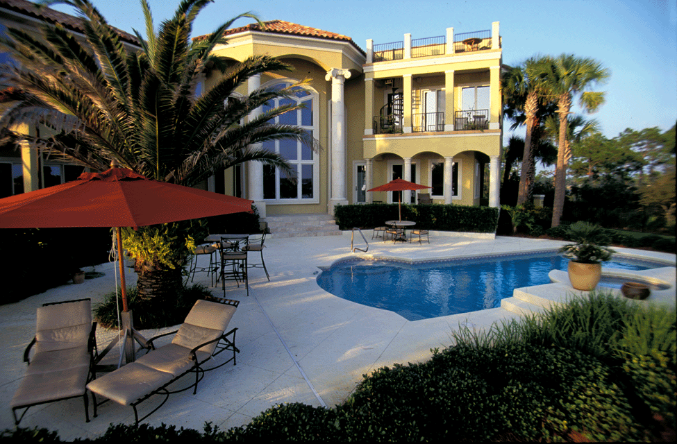 White church with steeple surrounded by trees; a blue sky is visible.