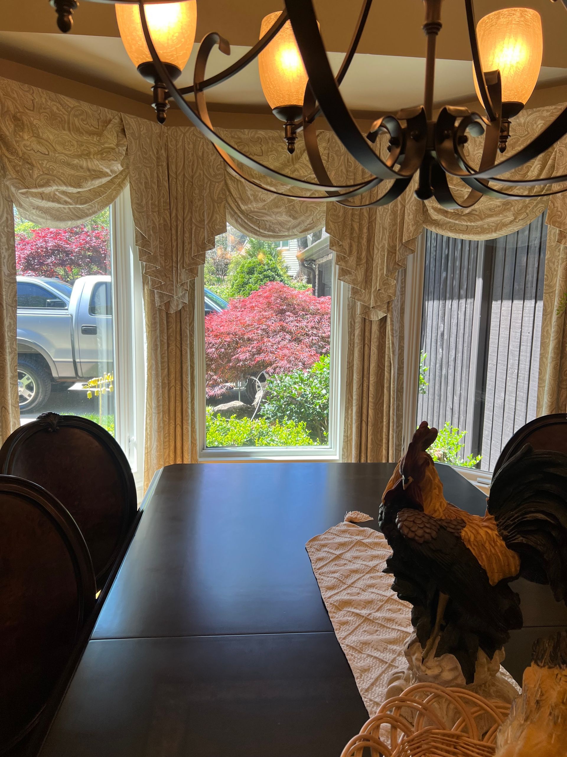 A dining room with a table and chairs and a chandelier
